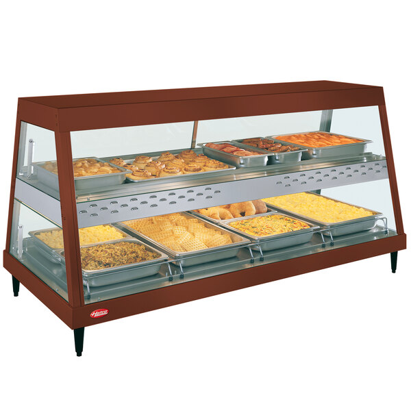 A Hatco countertop food warmer with trays of food on a display shelf.