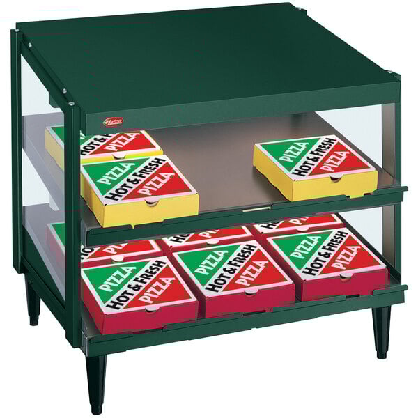 A Hunter Green Hatco countertop display case with pizza boxes inside.