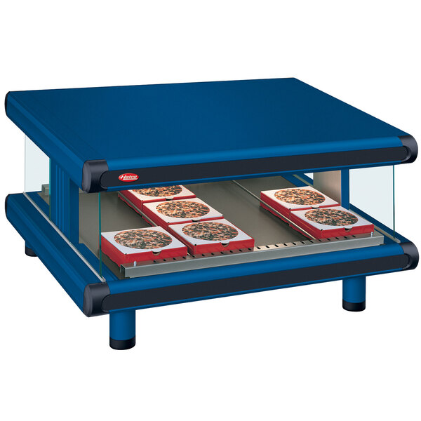 A blue Hatco countertop with a pizza on it.