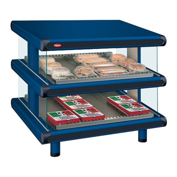 A blue Hatco countertop display case with food on shelves.