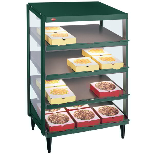 A green Hatco countertop food display case with pizza boxes inside.
