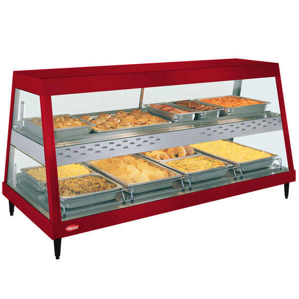 A red Hatco countertop display case with food on shelves.