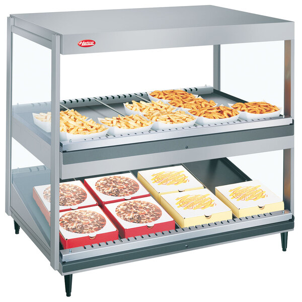 A Hatco countertop food warmer with trays of food on display.
