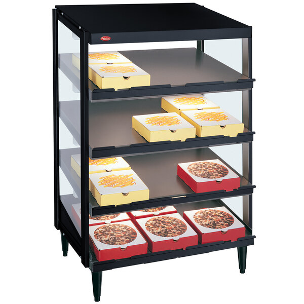 A black Hatco countertop pizza warmer with trays of pizzas on shelves.