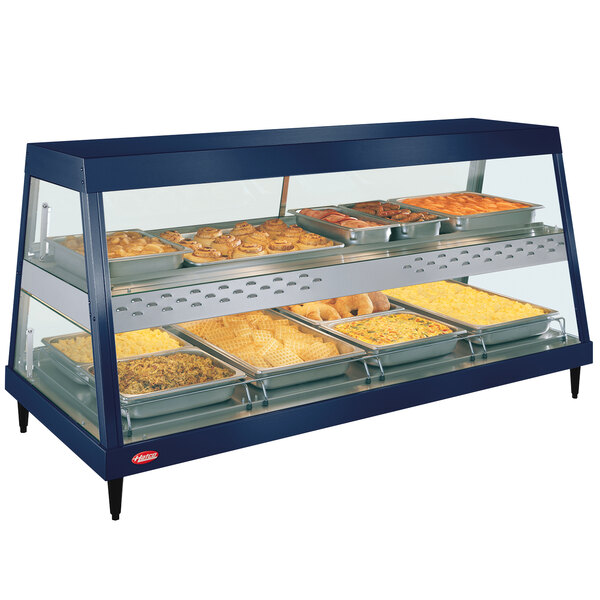 A Navy blue Hatco countertop food warmer with dual shelves holding trays of food.