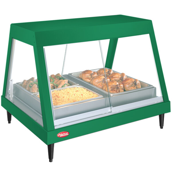 A Hunter Green Hatco countertop display warmer with food on a shelf.