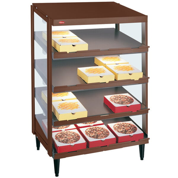 A Hatco countertop pizza warmer with trays of pizza on a shelf.