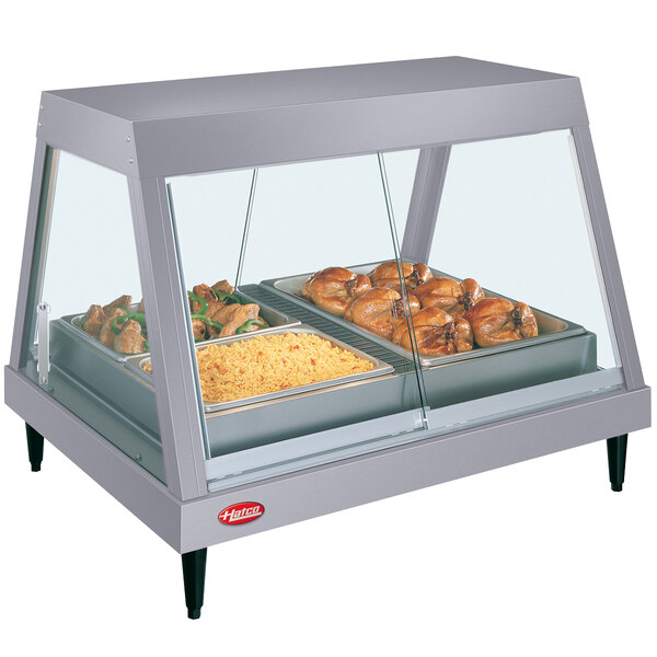 A Hatco countertop food warmer with a tray of food inside.