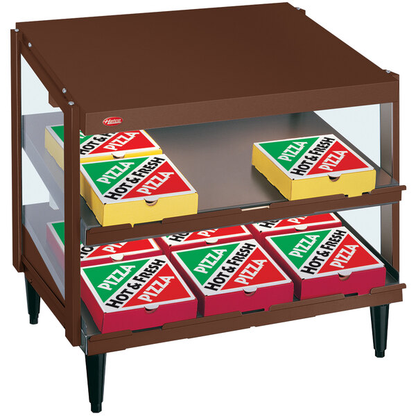 A Hatco countertop pizza warmer with pizza boxes inside.