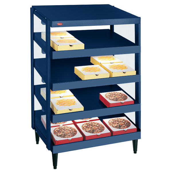 A blue Hatco countertop pizza warmer with pizza boxes on the shelves.