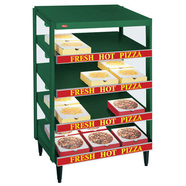 A Hunter green Hatco countertop pizza warmer displaying pizza on shelves.