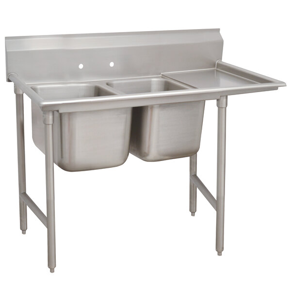 An Advance Tabco stainless steel two compartment sink with right drainboard.