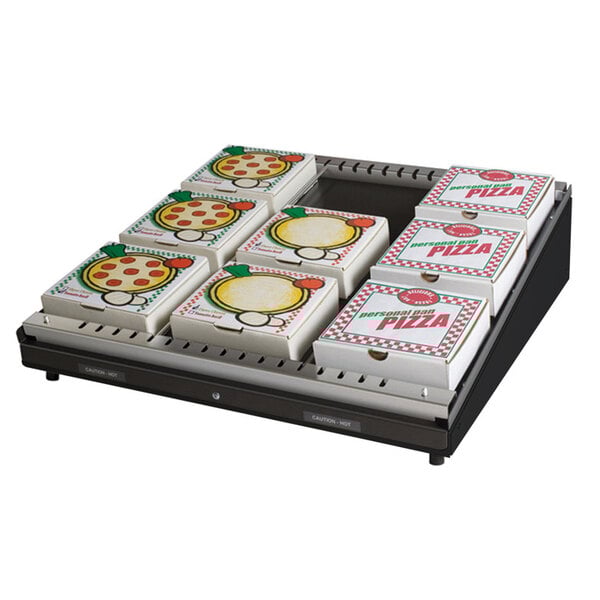 A stack of pizza boxes in a Hatco countertop pizza warmer.