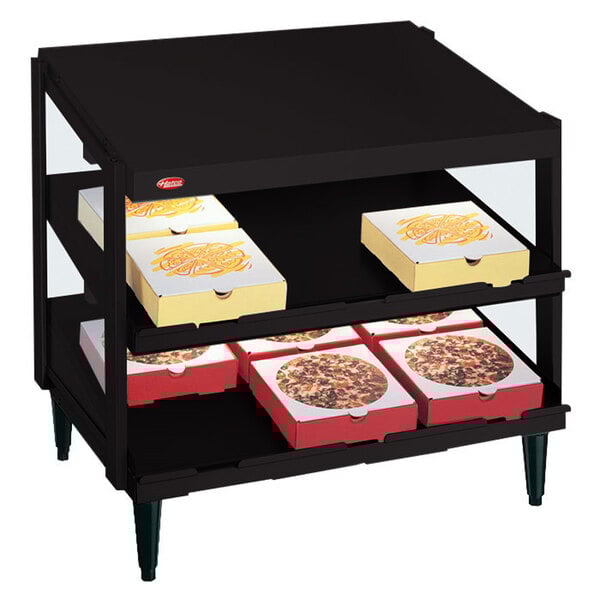 A black Hatco countertop display case with pizza boxes on it.