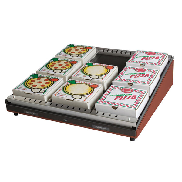 A Hatco countertop pizza warmer with a shelf of pizza boxes inside.