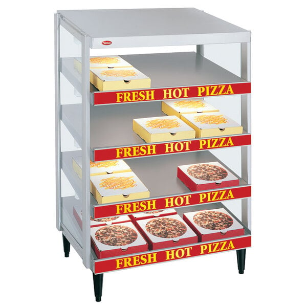 A Hatco granite white pizza warmer with pizza boxes on shelves.