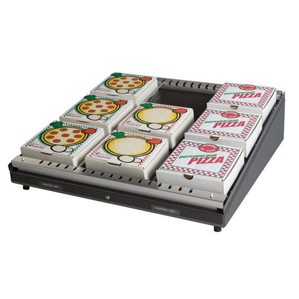 A Hatco Granite Gray Glo-Ray pizza warmer on a table with pizza boxes inside.