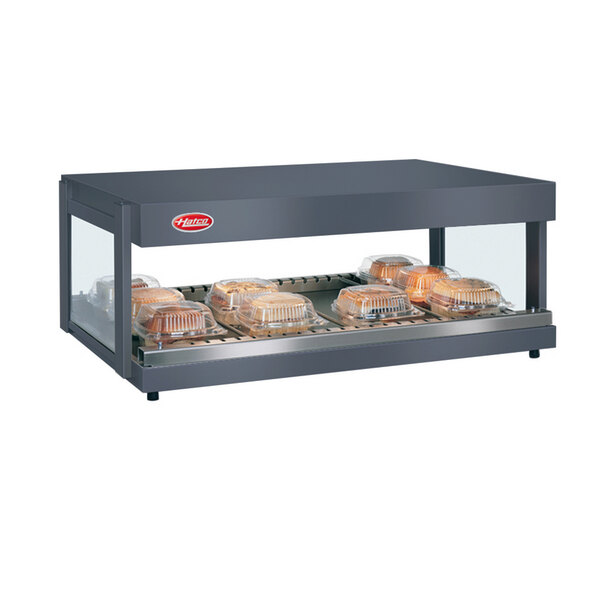 A Hatco countertop display with food trays in a glass case.