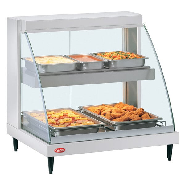 A Hatco Glo-Ray double shelf countertop food display case with food inside.