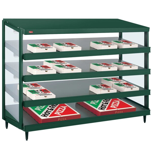 A Hunter green Hatco pizza warmer with pizza boxes on shelves.