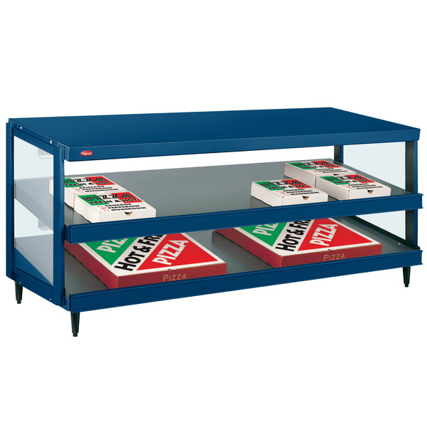 A blue shelf with boxes of pizza on it in a Hatco countertop display warmer.