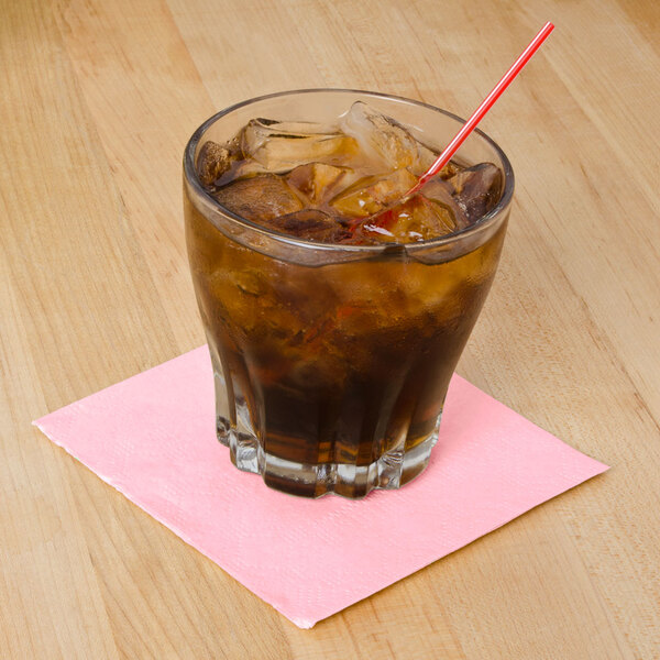 a straw in a glass with ice and brown liquid