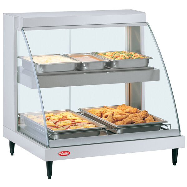 A Hatco white countertop display case with food inside.