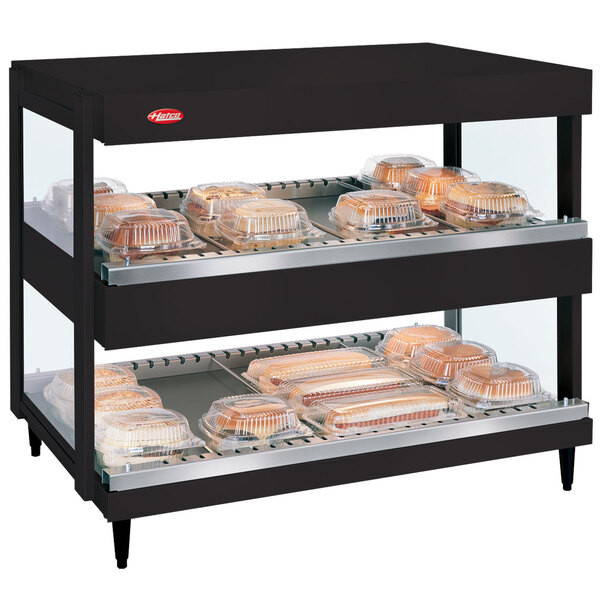 A black Hatco countertop display case with food trays inside.