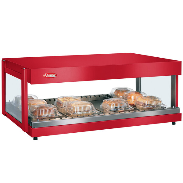 A red Hatco warm food display with clear containers of food on a counter.