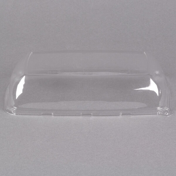 A clear plastic container with a high dome lid.