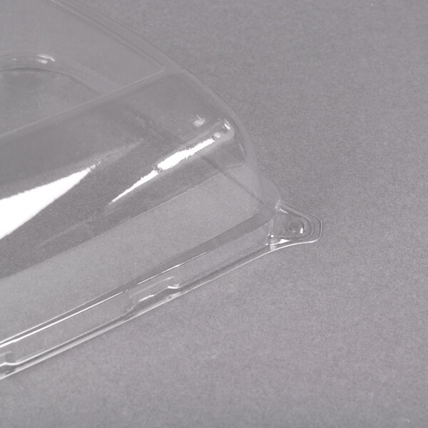 A clear plastic Sabert catering tray with a high dome lid.