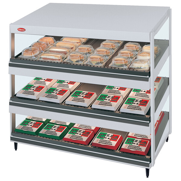 A Hatco Granite Glo-Ray countertop shelf display with food on it.