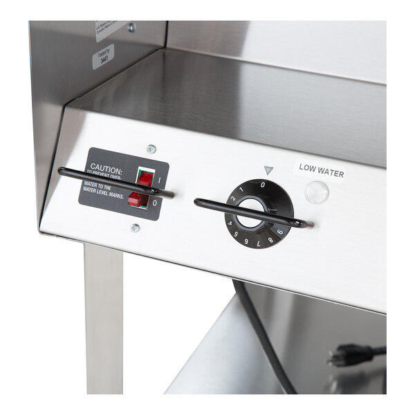 A stainless steel electric hot food table with control knobs and indicator lights.