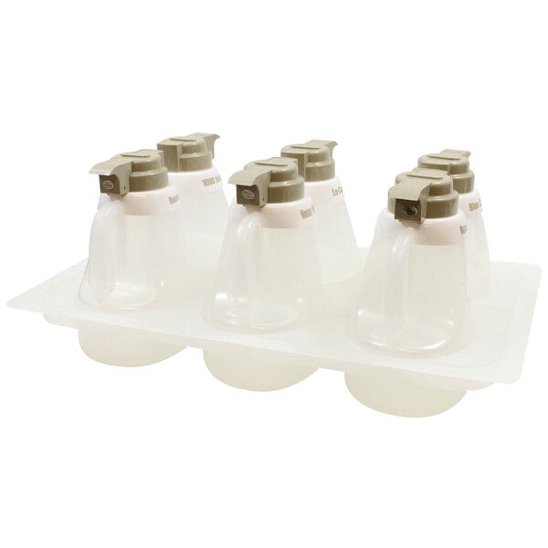 A Tablecraft beige plastic salad dressing dispenser set on a tray.