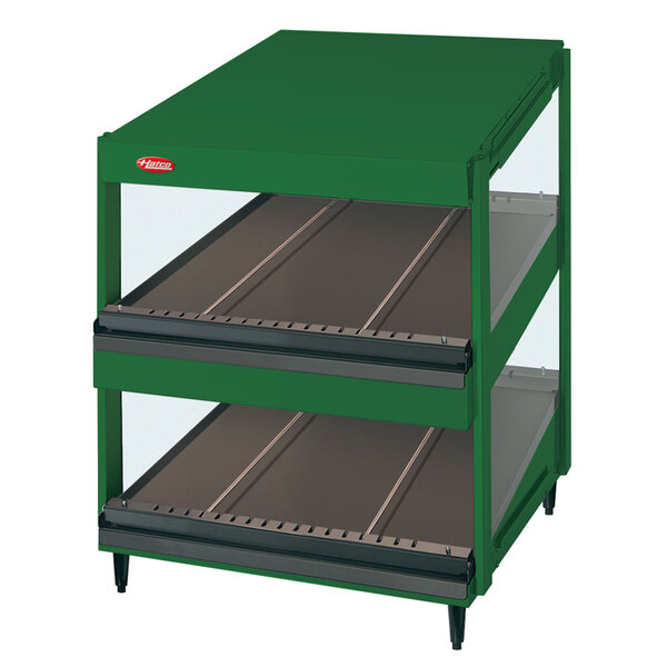 A green Hatco countertop display case with two slanted shelves inside.