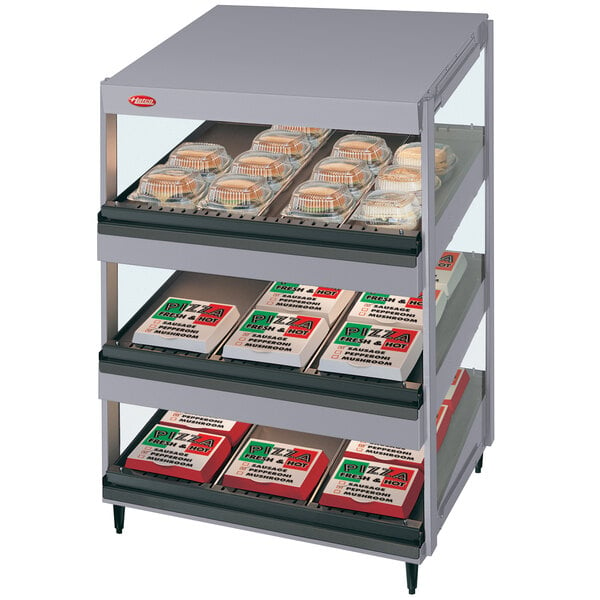 A Hatco countertop display shelf with food on it.