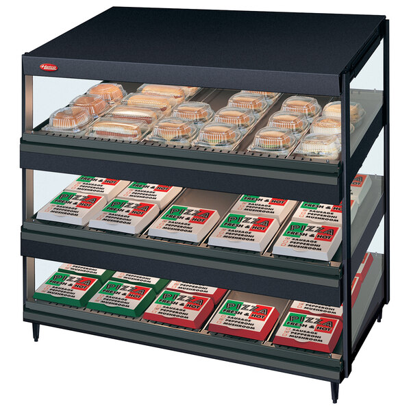 A black Hatco countertop display case with food on slanted shelves.
