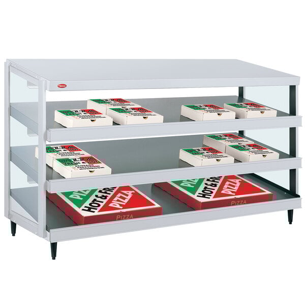 A Hatco Granite White pizza warmer shelf holding pizza boxes.
