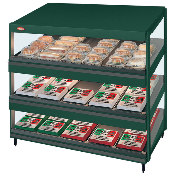 A Hunter Green Hatco display case with food on shelves.