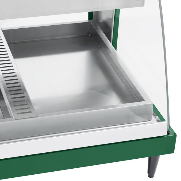 A green Hatco countertop display case with glass shelves and a glass door.
