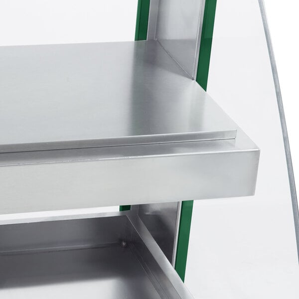 A green and silver Hatco countertop hot food display warmer with metal shelves.