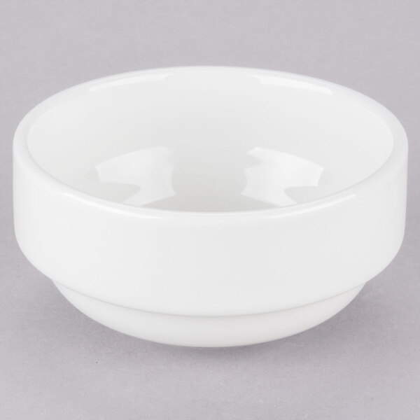 A close up of a Tuxton AlumaTux pearl white stackable bouillon bowl.
