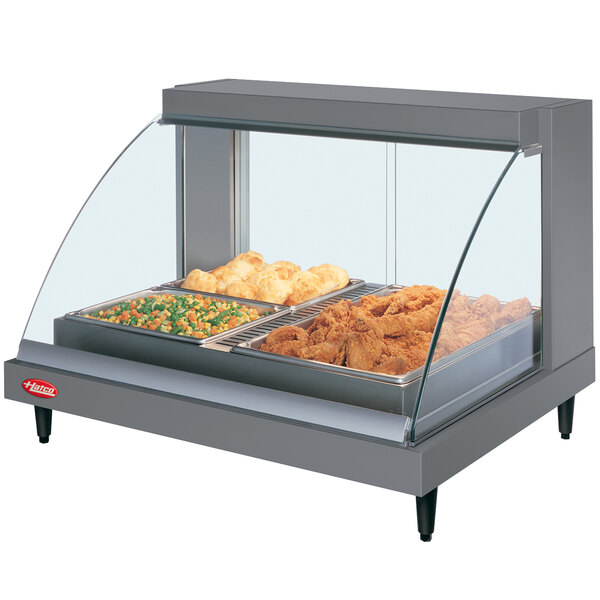 A Hatco countertop food display warmer with food on a tray inside.