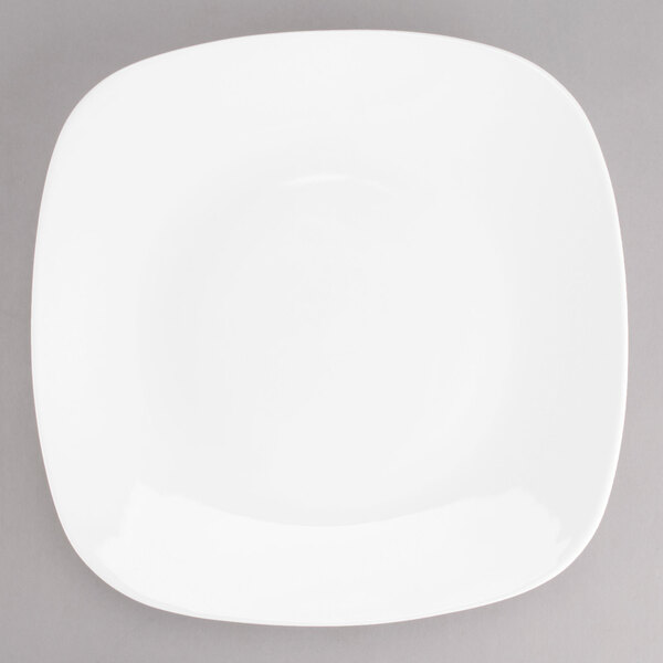 A Tuxton AlumaTux Pearl White square china plate with a white rim.