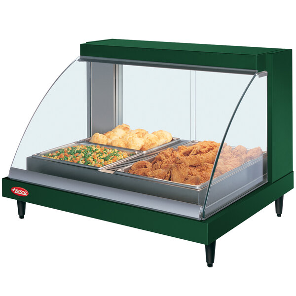 A Hatco green Glo-Ray countertop food warmer with food on a shelf.