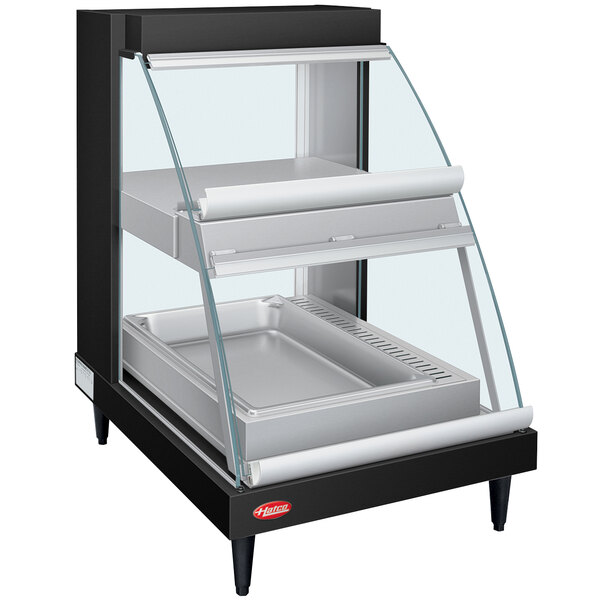 A black Hatco countertop display case with a glass door and double shelves.
