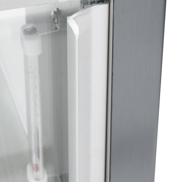 The open metal door of a gray Hatco Glo-Ray countertop warmer with a thermometer inside.