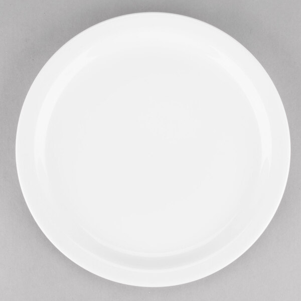 A Tuxton AlumaTux white china plate with a white rim on a gray surface.