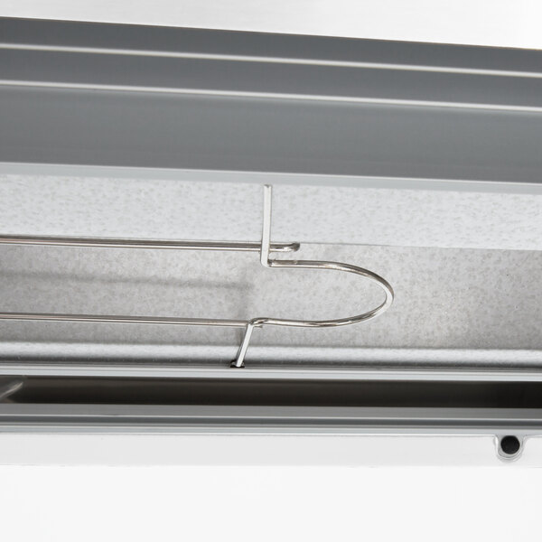A metal shelf in a Hatco countertop warmer with a metal hook.