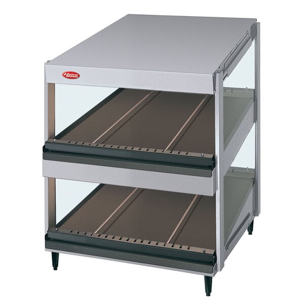 A Hatco white granite countertop merchandiser with slanted metal shelves.